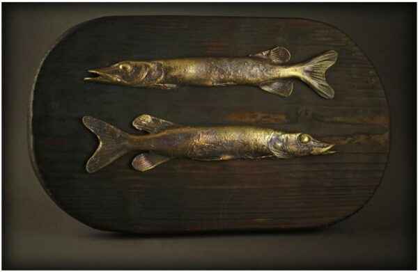 Handmade bronze pikes attached to a wooden table