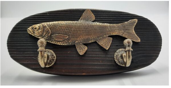 Handmade hanger with Bronze slag attached to a wooden table